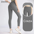 Calça legging feminina de cintura alta e modelagem slim para ioga, controle abdominal e academia.
